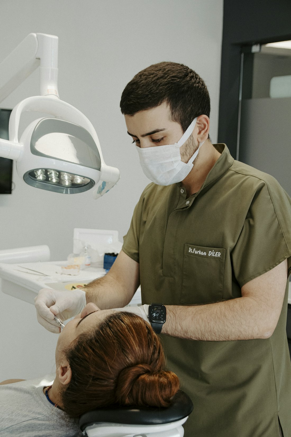 Cosmetic dentist examining a patient during a veneer consultation